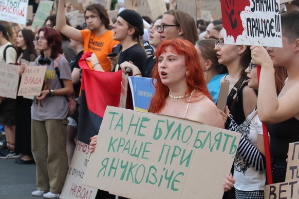 A demonstrator holds a placard reading It Wasnt Better Under Yanukovych during a protest action against draft law N12414 adopted on July 22, which reduces the powers of the National Anti-Corruption Bu ...