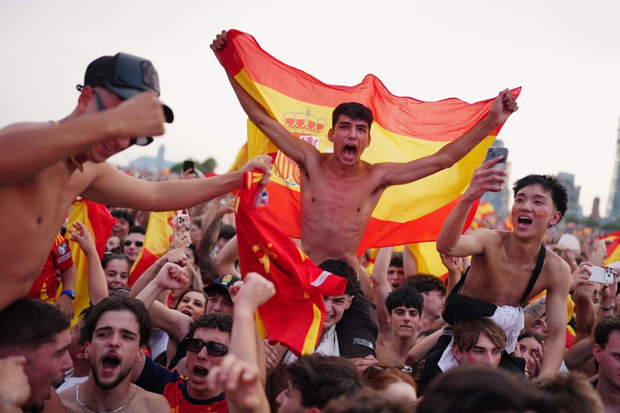 Spanish fans cheer for their team while watching the World Cup final soccer match between Spain and Argentina on giant screens in Barcelona, Sunday, July 19, 2026. The match is being played in East Ru ...