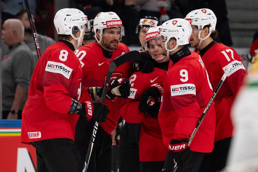 Switzerland's Roman Josi, second left, celebrates with the team after scoring the opening goal during the 2026 IIHF Men's Ice Hockey World Championship preliminary round group A match betwee ...
