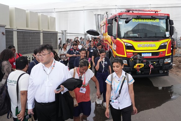 Attendees evacuate after a fire was reported inside the venue for the COP30 U.N. Climate Summit, Thursday, Nov. 20, 2025, in Belem, Brazil. (AP Photo/Joshua A. Bickel)
Climate COP30