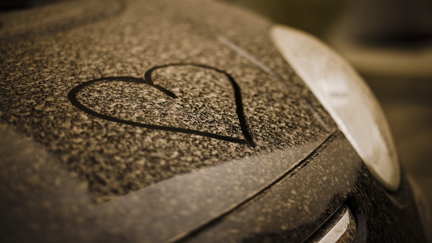A drawn heart is seen on a black painted car covered with sahara dust, in Zurich, Switzerland on March 15, 2022. (KEYSTONE/Michael Buholzer)