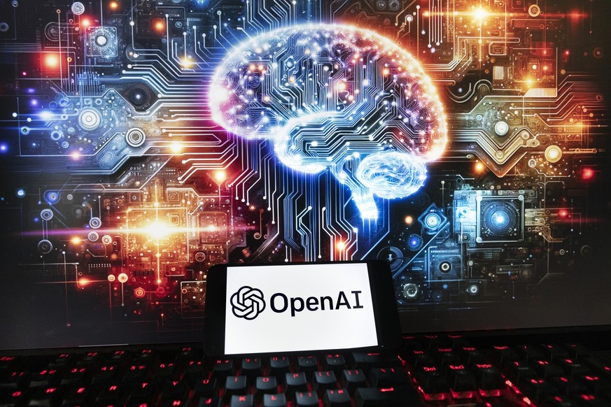 FILE - The OpenAI logo is seen displayed on a cell phone with an image on a computer monitor generated by ChatGPT&#039;s Dall-E text-to-image model, Friday, Dec. 8, 2023, in Boston. OpenAI says it&#03 ...