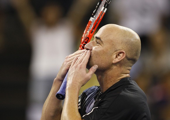 American Andre Agassi gives a fly kiss to fans after defeated by Pete Sampras during a friendly exhibition at the Venetian Hotel in Macau Sunday, Oct. 25, 2009. The two tennis greats revisited one of  ...