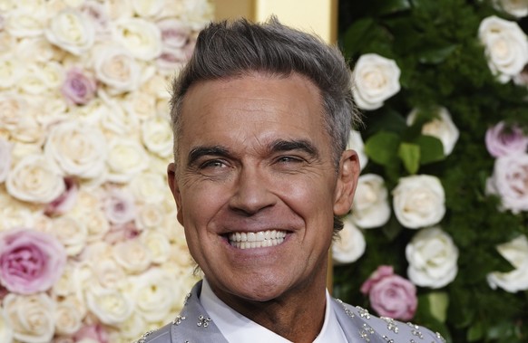Robbie Williams arrives at the 82nd Golden Globes on Sunday, Jan. 5, 2025, at the Beverly Hilton in Beverly Hills, Calif. (Photo by Jordan Strauss/Invision/AP)
Robbie Williams