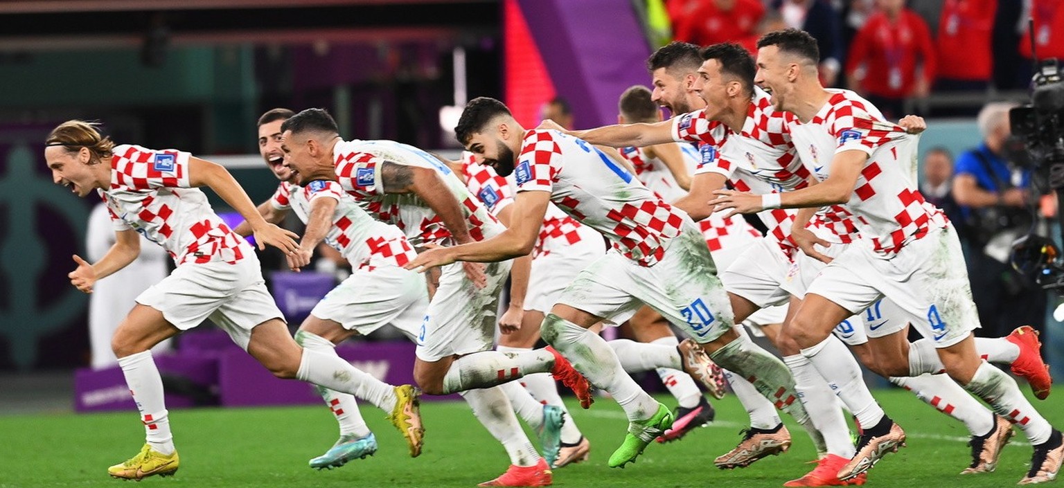 epa10357598 Players of Croatia celebrate after winning the penalty shoot-out of the FIFA World Cup 2022 quarter final soccer match between Croatia and Brazil at Education City Stadium in Doha, Qatar,  ...