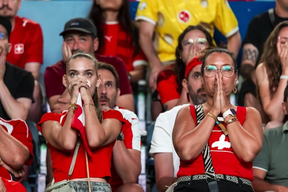 Swiss supporters react during the penalty kick shootout at public viewing of the FIFA 2026 World Cup round of 16 soccer match between Switzerland and Colombia, at the fan zone inside of the stade de l ...
