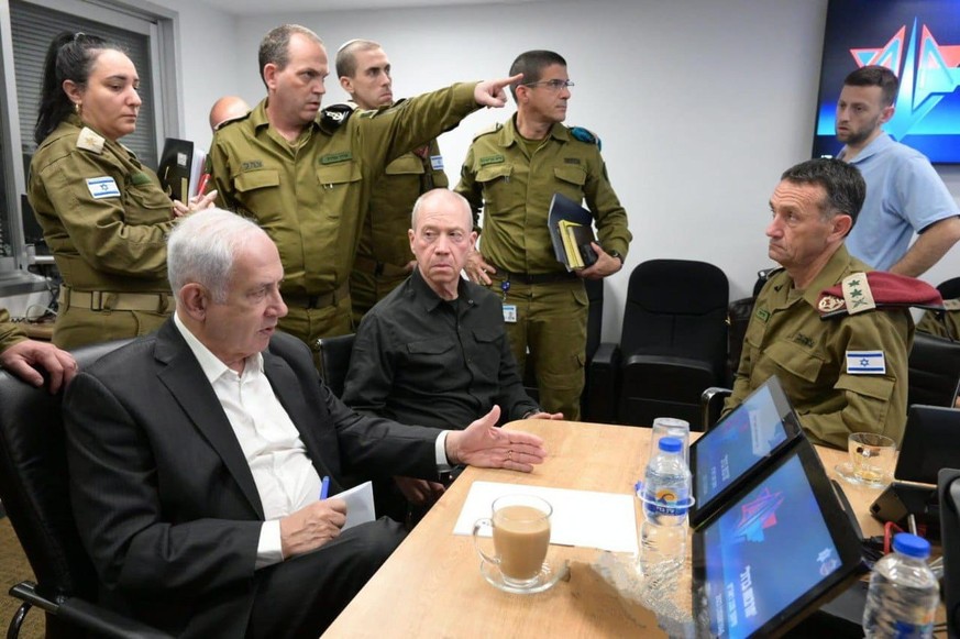 epa10907440 A handout photo made available by the Israeli Government Press Office shows Israeli Prime Minister Benjamin Netanyahu (L) during a situation assessment meeting in Tel Aviv, Israel, 08 Octo ...