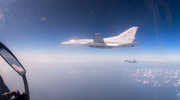 In this photo taken from video provided by the Russian Defense Ministry Press Service on Friday, Feb. 19, 2022, a Tu-22M3 bomber of the Russian air forces flies over the Mediterranean after taking off ...