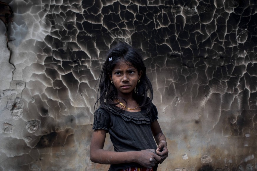 March 24, 2021: Cox s Bazaar, Bangladesh: A Rohingya girl in front of burned refugee camp where a massive fire broke out two days ago and destroyed thousands of shelters and at least fifteen people di ...