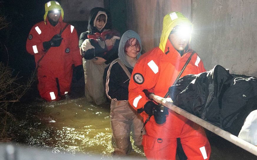 In this photo released by Governor of Sevastopol Mikhail Razvozhayev telegram channel, rescuers evacuee people after storm and flooding in Sevastopol, Crimea, Monday, Nov. 27, 2023. A storm in the Bla ...