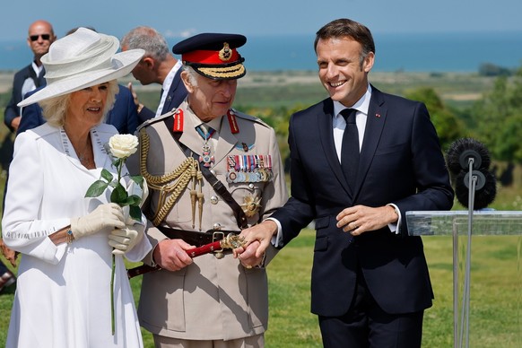epa11393222 (L-R) Britain's Queen Camilla, Britain's King Charles III and France's President Emmanuel Macron attend the UK Ministry of Defence and the Royal British Legion��&#x2122; ...