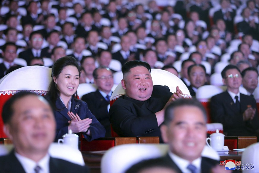 In this photo provided by the North Korean government, North Korean leader Kim Jong Un and his wife Ri Sol Ju watch a performance marking birth anniversary of Kim Jong Il, Pyongyang, North Korea, Tues ...