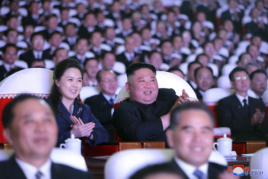 In this photo provided by the North Korean government, North Korean leader Kim Jong Un and his wife Ri Sol Ju watch a performance marking birth anniversary of Kim Jong Il, Pyongyang, North Korea, Tues ...