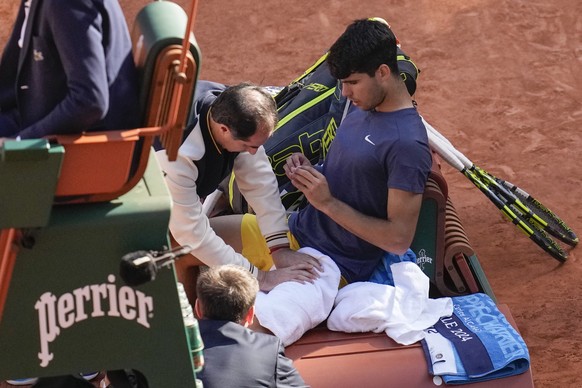 Spain&#039;s Carlos Alcaraz receives medical assistance in the men&#039;s final against Germany&#039;s Alexander Zverev at the French Open tennis tournament at the Roland Garros stadium in Paris, Fran ...