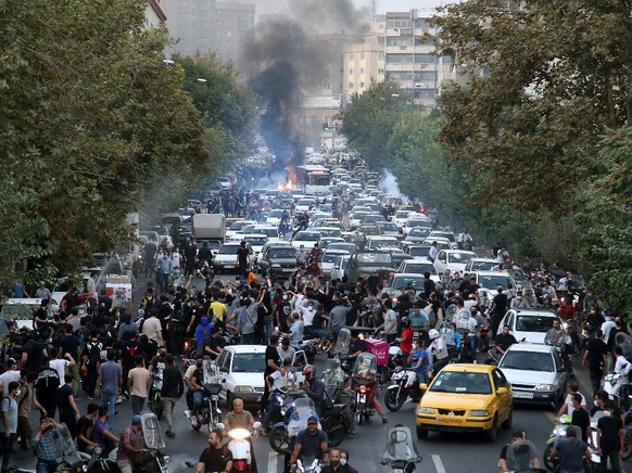 epa10197704 People clash with police during a protest following the death of Mahsa Amini, in Tehran, Iran, 21 September 2022. Mahsa Amini, a 22-year-old Iranian woman, was arrested in Tehran on 13 Sep ...