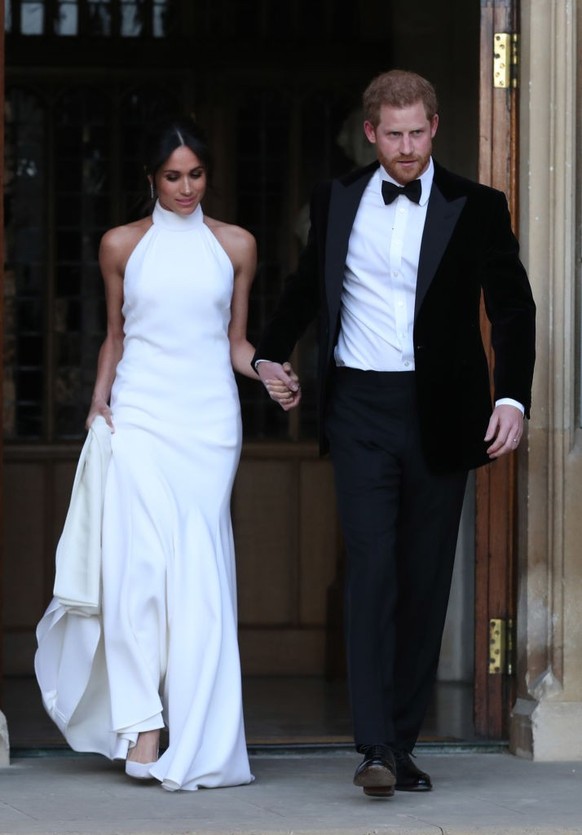 WINDSOR, UNITED KINGDOM - MAY 19: Duchess of Sussex and Prince Harry, Duke of Sussex leave Windsor Castle after their wedding to attend an evening reception at Frogmore House, hosted by the Prince of  ...