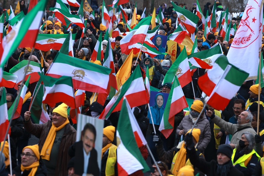 epaselect epa12712761 Participants hold pre-revolution flags of Iran, during a rally in solidarity with the people in Iran in front of the Brandenburg Gate in Berlin, Germany, 07 February 2026. The ra ...