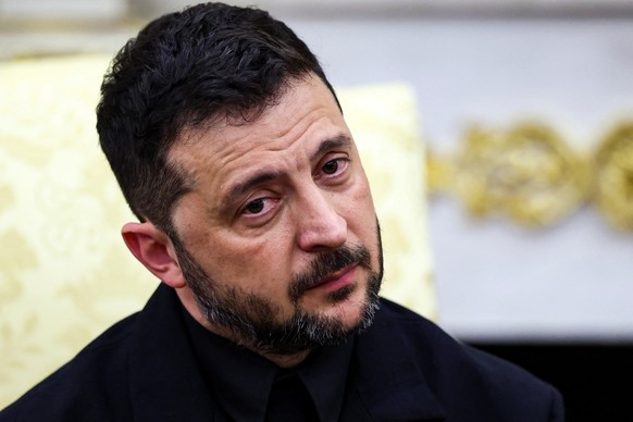 Ukrainian President Volodymyr Zelenskiy reacts during a meeting with U.S. President Donald Trump at the Oval Office of the White House, amid negotiations to end the Russian war in Ukraine, in Washingt ...