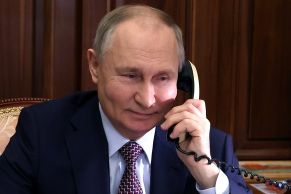 Russian President Vladimir Putin has a phone call in Moscow, Russia, Thursday, Dec. 21, 2023. (Mikhail Klimentyev, Sputnik, Kremlin Pool Photo via AP)