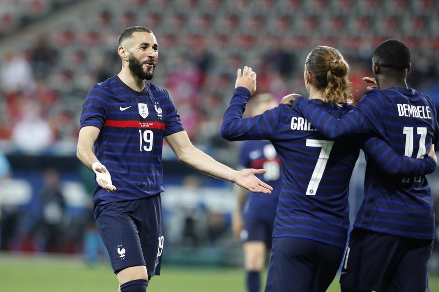 epa09243980 Ousmane Dembele (R) of France celebrates with teammates Karim Benzema (L) and Antoine Griezmann (C) after scoring the 3-0 lead during the International Friendly soccer match between France ...