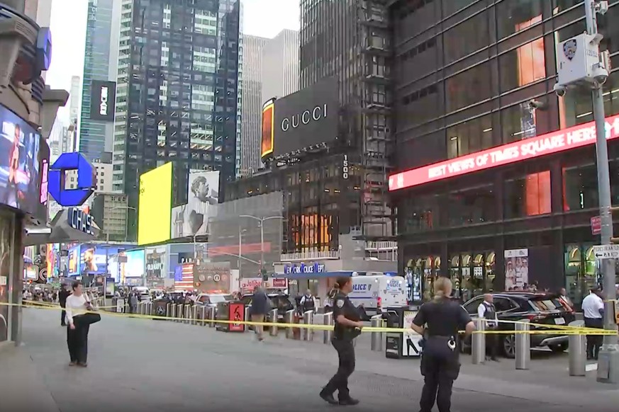 This image made from video provided by WABC-TV shows NYPD officers on the scene after a woman brandishing two large knives was shot by officers in Times Square in New York, Monday, Aug. 31, 2026. (WAB ...