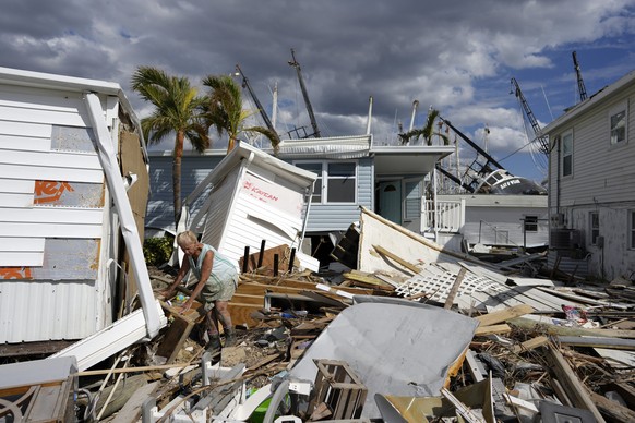 Kathy Hickey, 70, carefully picks her way through debris from destroyed trailers in the mobile home park where she and her husband Bruce had a winter home, a trailer originally purchased by Kathy&#039 ...