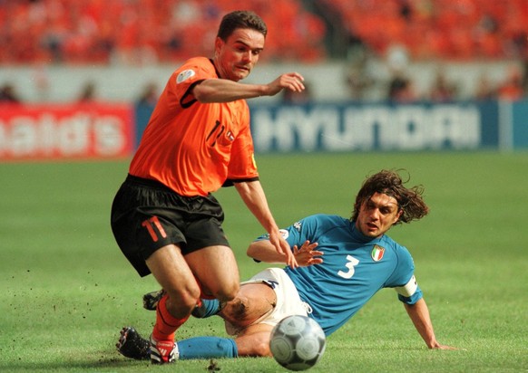 Italy captain Paolo Maldini (r) brings down Holland's Marc Overmars (l) (Photo by Matthew Ashton/EMPICS via Getty Images)