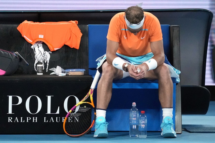 Rafael Nadal of Spain rests in his chair between games during his second round match against Mackenzie McDonald of the U.S., at the Australian Open tennis championship in Melbourne, Australia, Wednesd ...