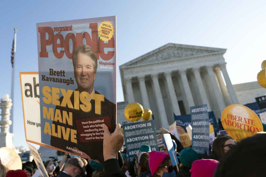 Abortion rights advocates holding a picture of associate justice Brett Kavanaugh demonstrate in front of the U.S. Supreme Court Wednesday, Dec. 1, 2021, in Washington, as the court hears arguments in  ...