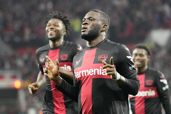 FILE - Leverkusen&#039;s Victor Boniface, center, celebrates with teammate Edmond Tapsoba, left, after scoring during the Europa League Group H soccer match between Bayer Leverkusen and Qarabag at the ...