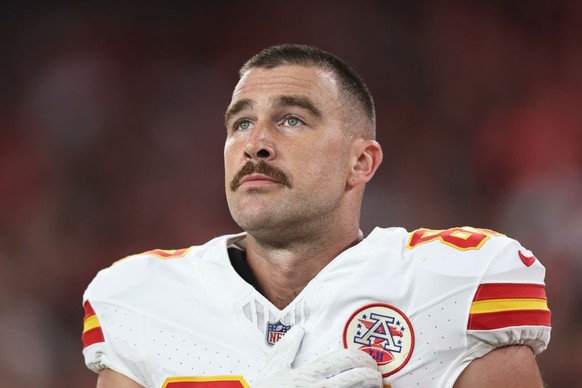 GLENDALE, ARIZONA - AUGUST 19: Travis Kelce #87 of the Kansas City Chiefs looks on during the national anthem prior to an NFL preseason football game between the Arizona Cardinals and the Kansas City  ...
