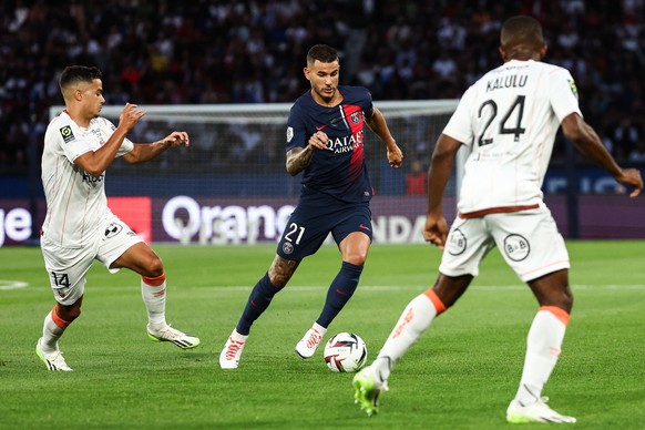 epa10797713 Paris Saint Germain&#039;s Lucas Hernandez (C) in action with Lorient&#039;s Kalulu Kyatengwa Geeon (R) and Faivre Romain (L) during the French Ligue 1 soccer match between Paris Saint Ger ...