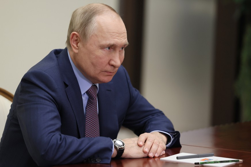 Russian President Vladimir Putin listens to Krasnodar Region Governor Veniamin Kondratyev during their meeting in the Black Sea resort of Sochi, Russia, Tuesday, Nov. 1, 2022. (Mikhail Metzel, Sputnik ...