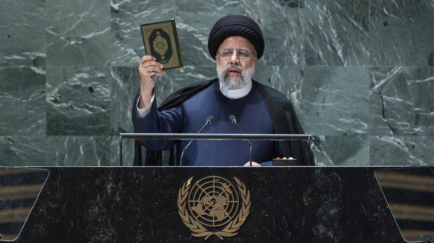 epa10870552 Iran&#039;s President Seyyed Ebrahim Raisi holds up a book while addressing the 78th session of the United Nations General Assembly at the United Nations Headquarters in New York, New York ...