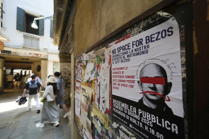 A &#039;No Jeff Bezos wedding&#039; protest poster is attached on a wall in Venice, Italy, Thursday, June 12, 2025. (AP Photo/Luca Bruno)