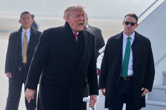 President Donald Trump, center, speaks as he steps off Air Force One after arriving at Zurich International Airport for the World Economic Forum, Wednesday, Jan. 21, 2026, in Zurich, Switzerland. (AP ...