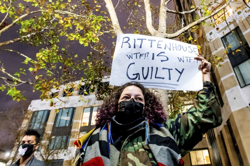 A demonstrator holds a sign Friday, Nov. 19, 2021, in Oakland, Calif., following the acquittal of Kyle Rittenhouse in Kenosha, Wis. Asserting self-defense, Rittenhouse was acquitted of all charges Fri ...