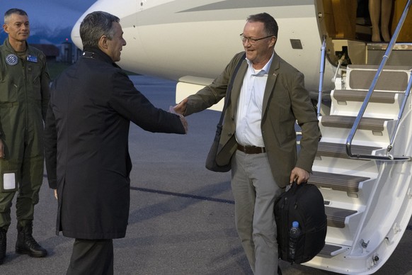 Swiss Federal Councilor Ignazio Cassis, left, welcomes Christian Winter, Swiss Ambassador of Sudan, at the Bern-Belp Airport in Belp, Switzerland, Tuesday, April 25, 2023. Swiss nationals are flown ou ...
