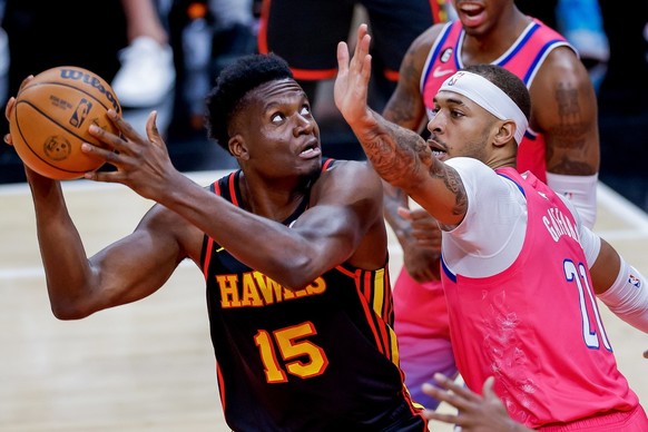 epa10496137 Atlanta Hawks center Clint Capela (L) of Switzerland in action against Washington Wizards center Daniel Gafford (R) during the first half of the NBA basketball game between the Washington  ...