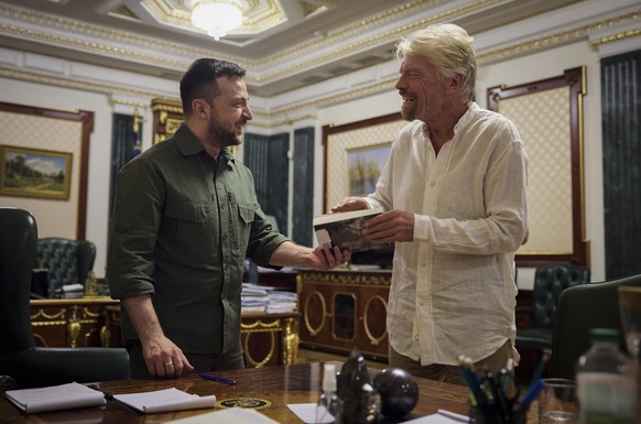 In this image provided by the Ukrainian Presidential Press Office, Ukrainian President Volodymyr Zelenskyy, left, and Virgin Galactic founder Richard Branson talk during their meeting in Kyiv, Ukraine ...