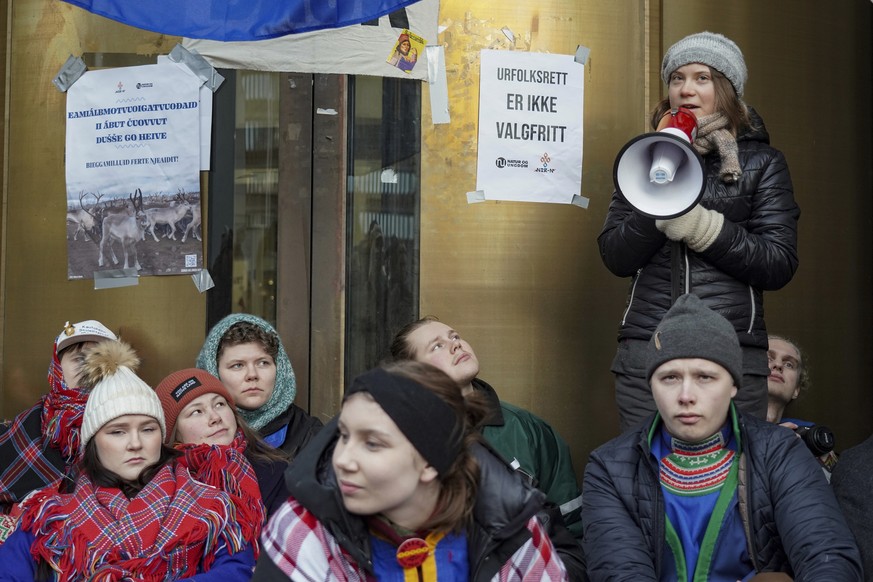 Greta Thunberg, right, joins the campaigners from Nature and Youth and Norwegian Samirs Riksforbund Nuorat who are blocking the entrances to the Ministry of Oil and Energy in Oslo Monday morning, Feb. ...