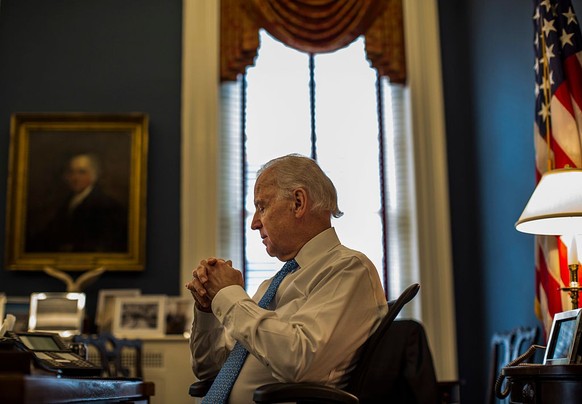 WASHINGTON, DC - MARCH 13: During a quiet moment at his desk, Vice President Joe Biden meets with staff in his office at the White House on Wednesday, March 13, 2013. (Photo by Melina Mara/The Washing ...