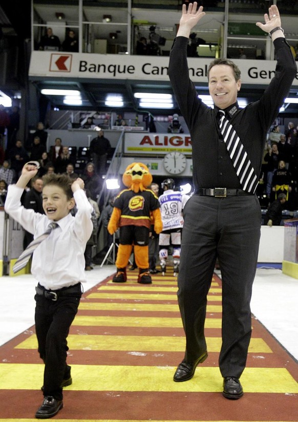 Chris McSorley, droite, entraineur du Geneve-Servette HC, fete la victoire avec son fils Aidan, gauche, et le public, apres la victoire de son equipe lors du 5e match des demi finales de play off du N ...