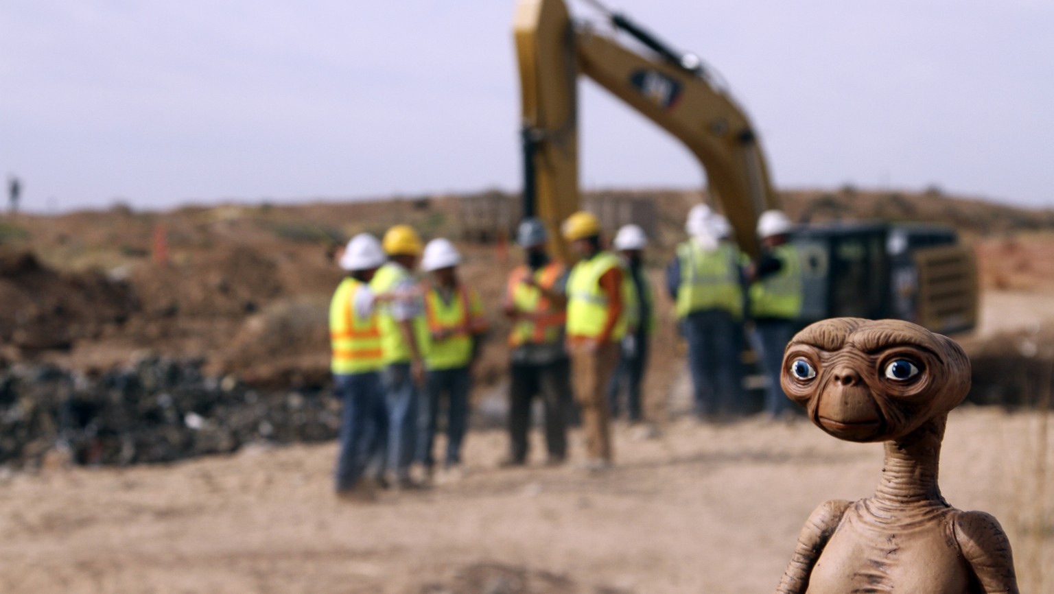 An E.T. doll is seen while construction workers prepare to dig into a landfill in Alamogordo, N.M., Saturday, April 26, 2014. Producers of a documentary are digging in the landfill in search of millio ...