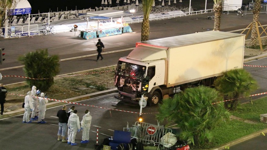 Authorities investigate a truck after it plowed through Bastille Day revelers in the French resort city of Nice, France, Thursday, July 14, 2016. France was ravaged by its third attack in two years wh ...