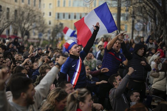 Fans sing the national anthem along with the team before the start of the World Cup final soccer match between France and Argentina, in Marseille, southern France, Sunday, Dec. 18, 2022. (AP Photo/Dan ...