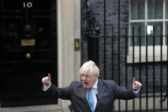 Outgoing British Prime Minister Boris Johnson gestures as he speaks outside Downing Street in London, Tuesday, Sept. 6, 2022 before heading to Balmoral in Scotland, where he will announce his resignat ...