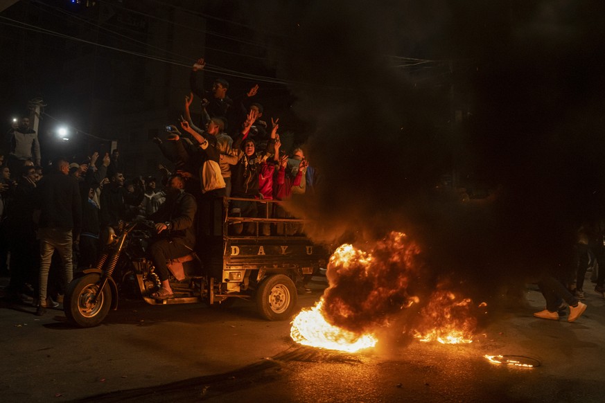 Palestinians celebrate after a shooting attack near a synagogue in Jerusalem, in Gaza City, Friday, Jan. 27, 2023. A Palestinian gunman opened fire outside an east Jerusalem synagogue Friday night, ki ...