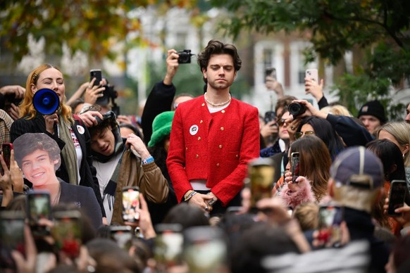 LONDON, ENGLAND - NOVEMBER 09: Mitch, the eventual runner-up in a Harry Styles lookalike competition, is cheered by fans of the former One Direction singer during a round of judging at Soho Square on  ...