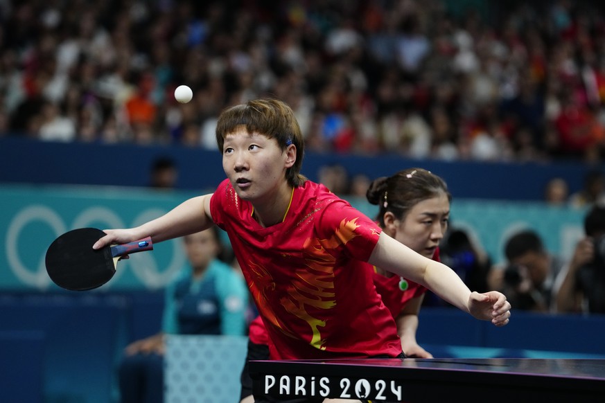 China&#039;s Wang Manyu, foreground, and Chen Meng play against Japan&#039;s Miwa Harimtoto and Hina Hayata during the women&#039;s gold medal team table tennis match at the 2024 Summer Olympics, Satu ...